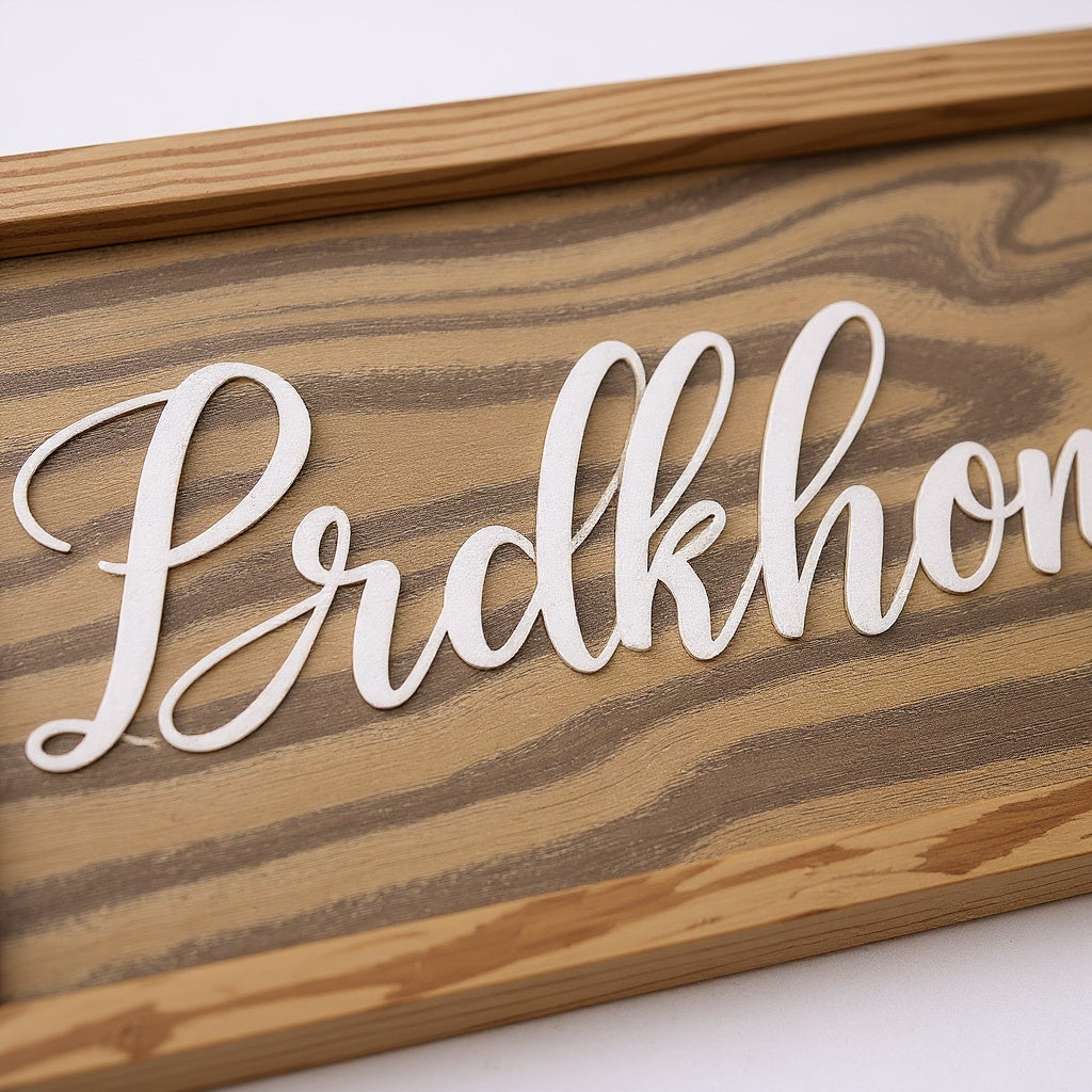 Close-up of hand-stained natural pine wood grain and 3D precision laser cut lettering